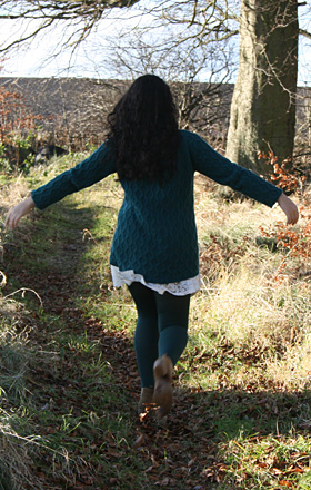 Girl walking through woodland